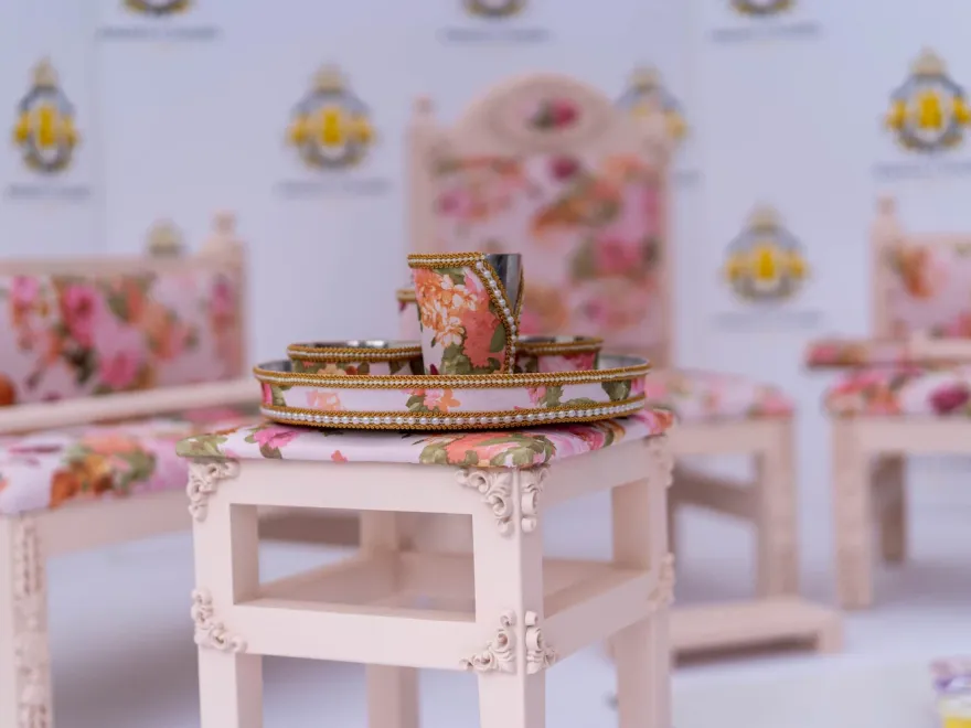 The Enchantress suite — carved blush frames with rose floral upholstery, tray table and sagan tray